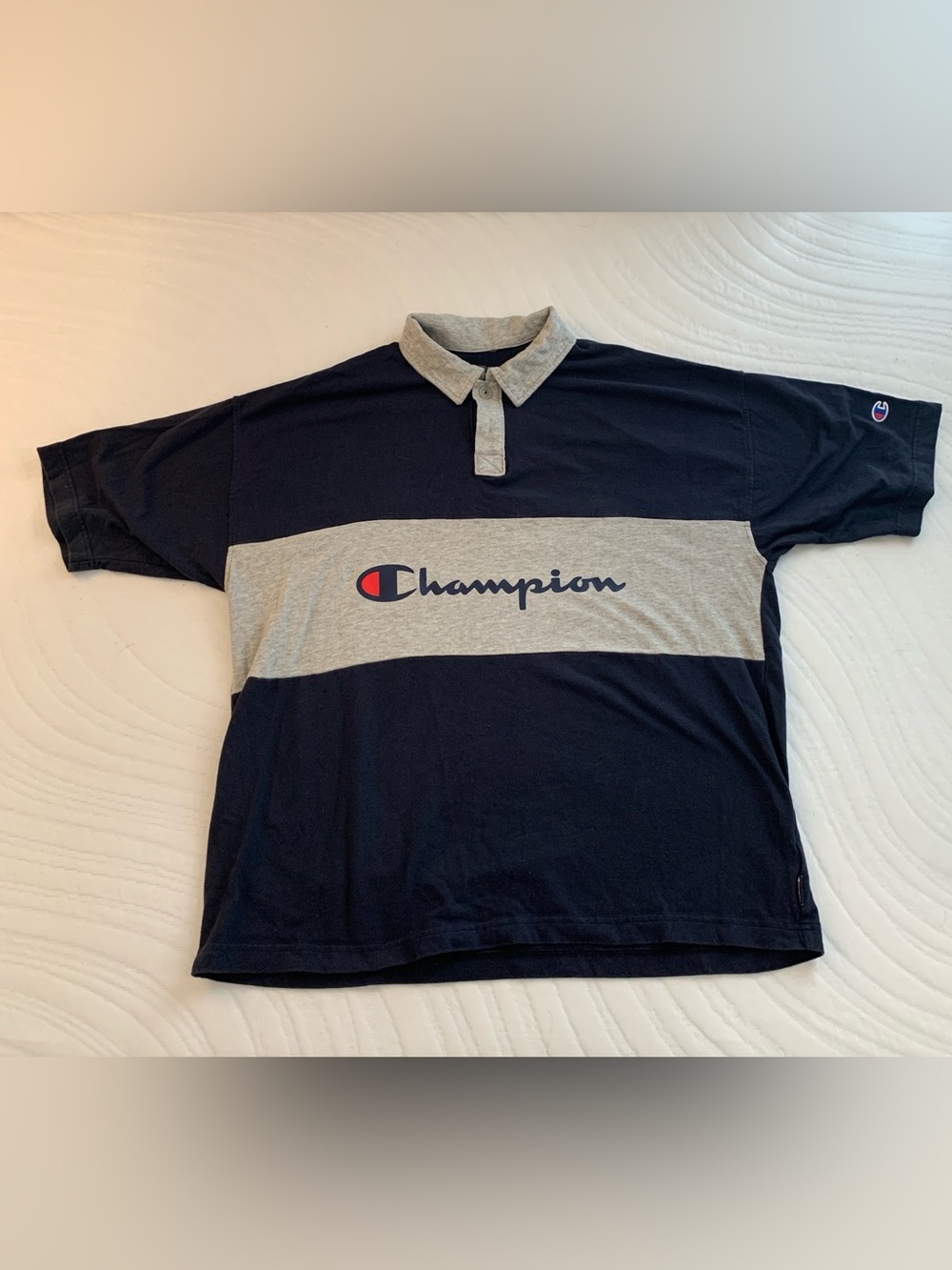 Champion navy blue short sleeve rugby shirt with gray stripe